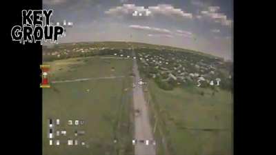 A Ukrainian drone operator spots a Russian 9K33 "Osa" air defense system on the move. Sends in an FPV quad to attack it. The Russian crew is trying to save it, even calls for the firefighters.