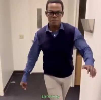 Chidi walking in his red boots
