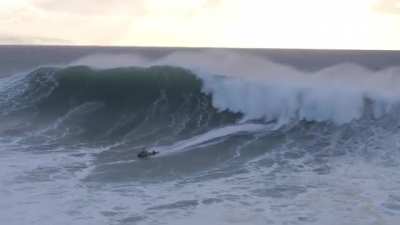 Jet skiier saving surfer from monster wave