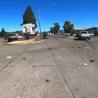 Biker gets up and confronts driver after sliding under truck