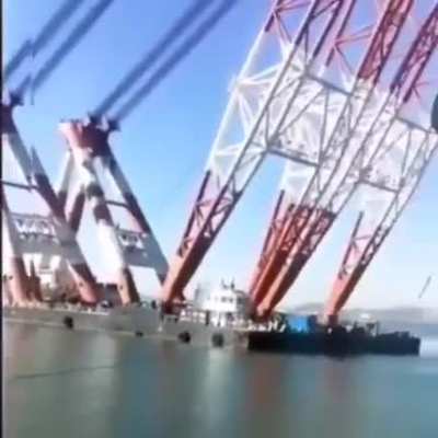 The world's largest floating crane, the "Hyundai 10000," can lift massive ships out of the water.