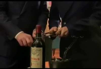 How to open a 1961 Château Péteus ($10000-$15000) with heating tools to keep the cork intact.
