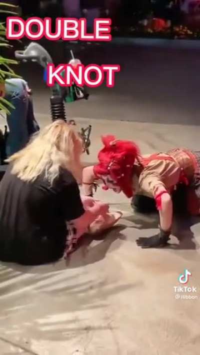 A clowns giving a nice shoe tying lesson