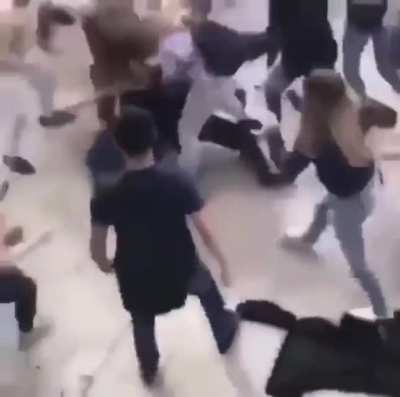 Guy gets jumped when he punches the wrong girl.