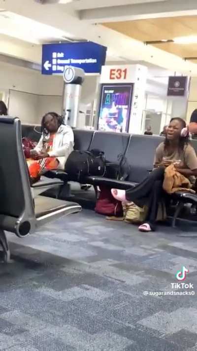 Lady irritates airport by singing at the top of her lungs.
