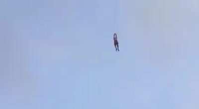 Man swept into the the air while flying a kite