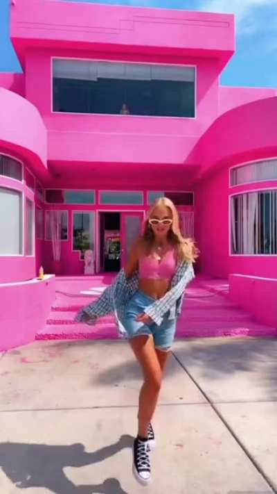 Barbie girl in front of Barbie house