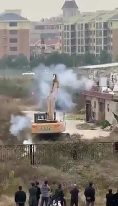 Man in China uses fireworks to fight off bulldozer sent to demolish his building