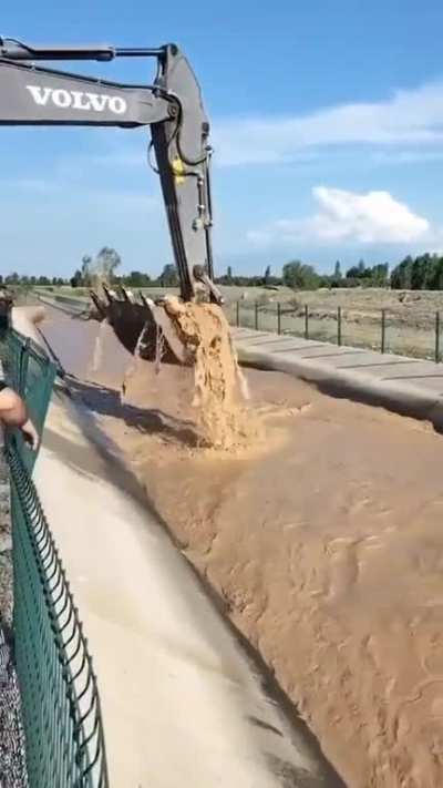 A cow drifting in a canal saved by an excavator. I&Auml;d&Auml;&plusmn;r, Turkiye