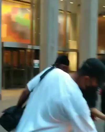 Protesters in NYC burn an American flag and a portrait of Tucker Carlson in front of Fox News HQ