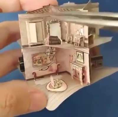 This tiny pop-up dollhouse in a book
