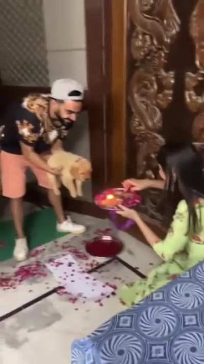 Indian family welcome new family member into their home with a traditional welcome.