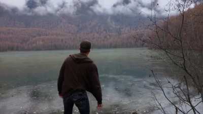 Dude enjoying himself at a frozen lake