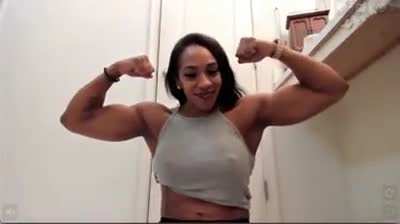 Powerful girl flexes massive biceps.