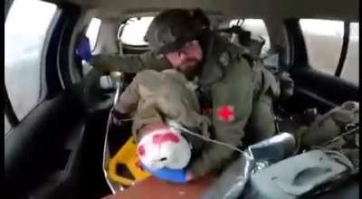 "Everything's gonna be OK, brother. You're gonna live." Polish volunteer trying to comfort a wounded Ukrainian soldier.