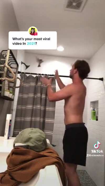 man has bird in bathroom