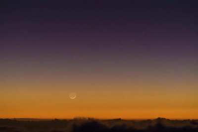 Moonset behind sea of clouds