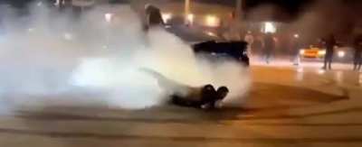 Man hanging from a car who does donuts falls and gets ran over by the same car