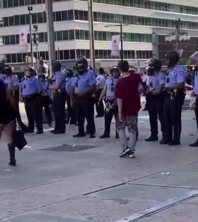 Protestor tempting cops with a donut