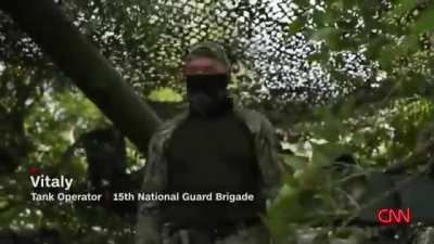 ru pov: CNN interviewing Ukrainian "tank operator" from "15th national guard brigade" wearing WWII era German Nazi eagle and swastika on his cap