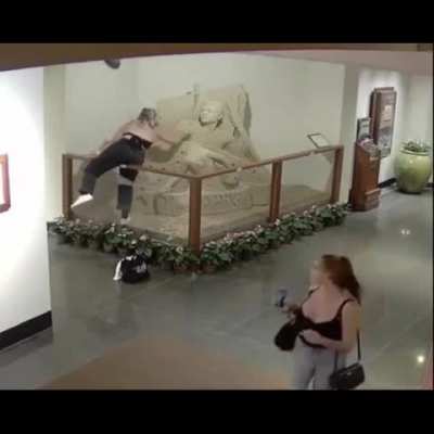 Girl destroys sand sculpture
