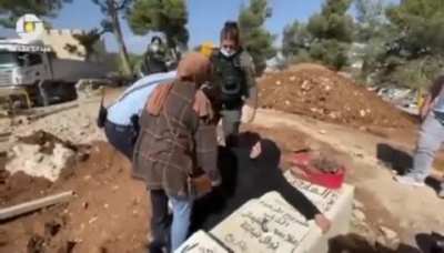 screaming &ldquo;Leave me to die with him&rdquo;, Israeli forces attacking and forcibly pulling a Palestinian mother from her son's grave as she tried to prevent them from destroying the grave