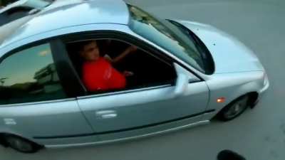 Two guys get sprayed like flys while trying to beat the motorcycle dude