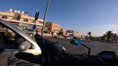 Motorcyclist thinks it&rsquo;s the other person&rsquo;s fault that he lost a mirror when squeezing between two full lanes at a stop.