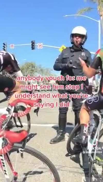 cop lecturing bicyclists