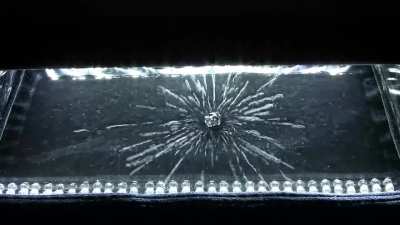 Uranium emitting radiation inside a cloud chamber. 