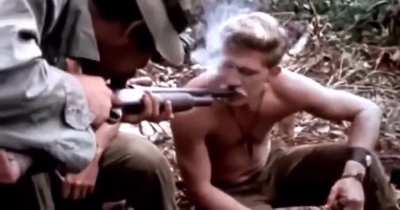 American soldiers in Vietnam smoking Marijuana out of the barrel of a Shotgun, 1970
