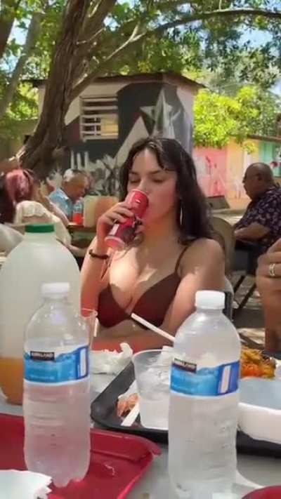 Dafne Keen drinking a soda