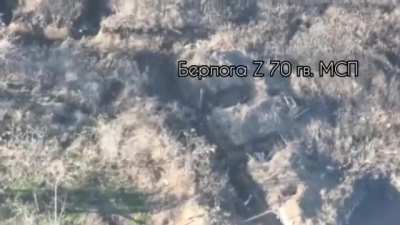 2 Russian soldiers clear a Ukrainian trench near Robotyne