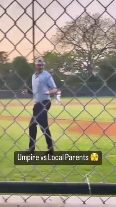 A couple spending some *relaxing* family time at a little league game