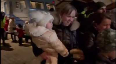 How refugees are greeted by Poles at the station after traveling by train to Przemyśl, Poland.