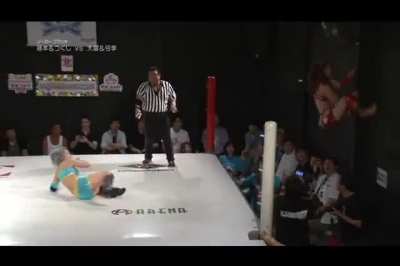 Wrestler interacts with a lucky fan during a match.