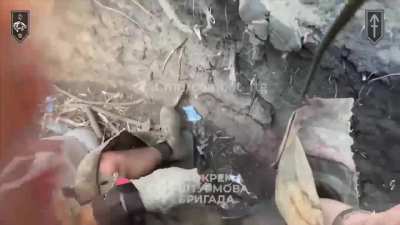 Soldier from the 3rd Assault Brigade  taking a hit from a frag grenade and getting treated quickly