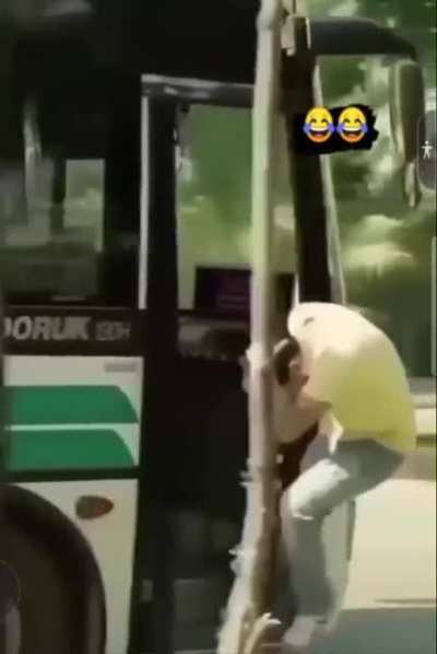 Leaning out of a moving bus.