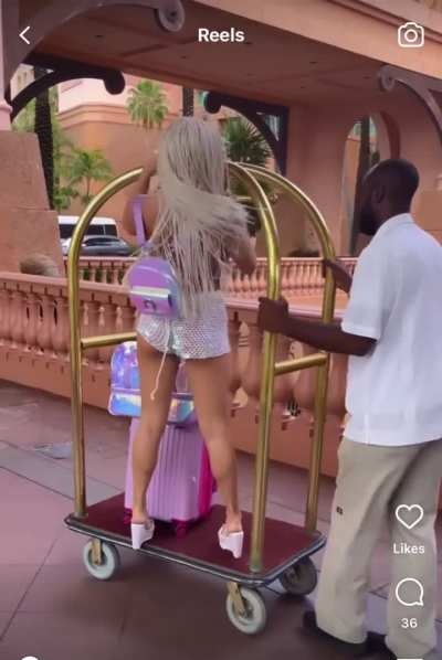 The workers look so annoyed. The one guy even shakes his head &ldquo;no&rdquo; when she&rsquo;s on the luggage cart