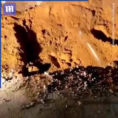 Rescuers dig up road to save dog trapped in drainage pipe