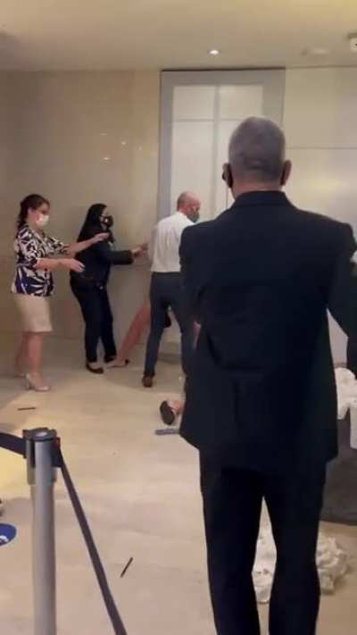 Karen gets upset because man who is a Gold or Diamond Hilton member is getting service before everyone else. Assaults that man and gets her partner knocked out.