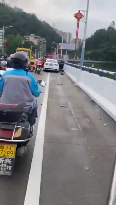 Aftermath of car colliding onto motorcycles/mopeds on a bridge. At first you see only 1 cyclist but the farther you go the more you see.