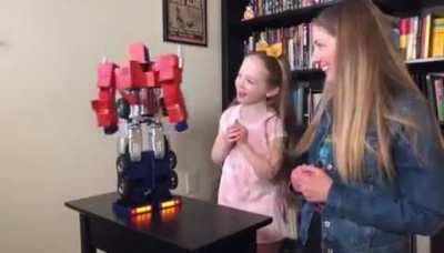 Little girl reacting to Optimus Prime toy