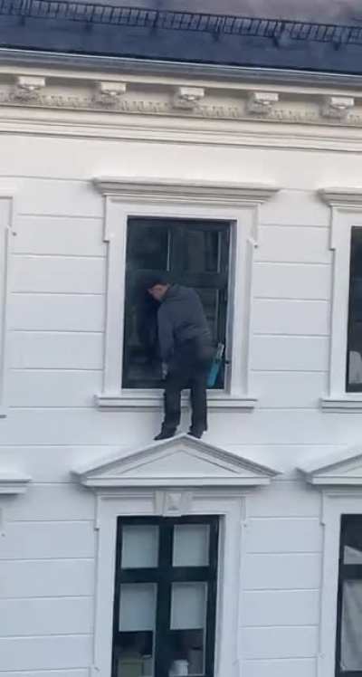 Washing windows on the 5th floor