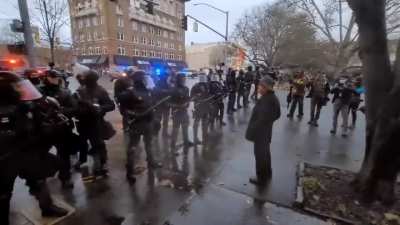 Police betray the Proud Boys, so they respond by walking on the American "thin blue line" flag