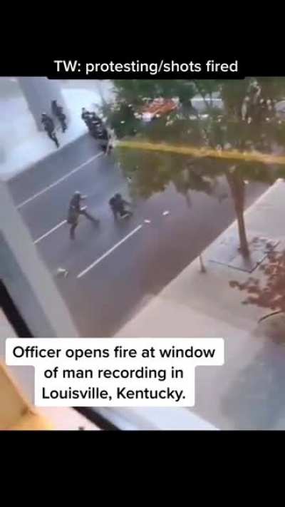 Guy video taping a breakout between protestors and the police.