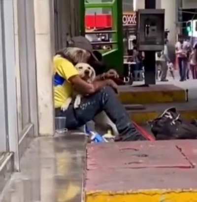Someone’s dog approaches homeless man and seems to know what he needs.. 1 hug comforts two hearts!
