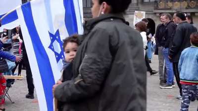 Mother makes her child spit on flag