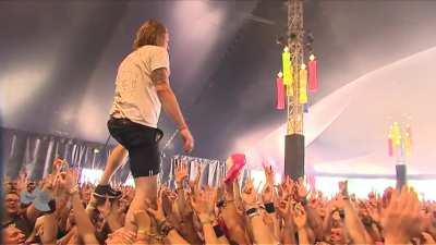 Singer catches beer while crowdwalking