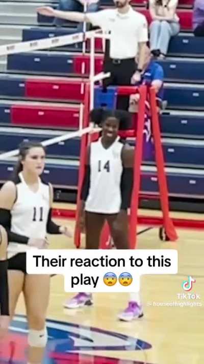 Girl slammed during volleyball match.